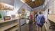 Visitors take a look at the interior of a tiny house designed and built by college students. The houses will eventually house homeless people in a tiny house village in Austin and Chicago.